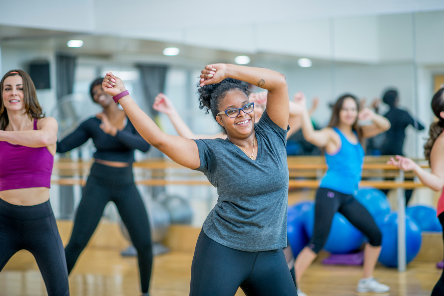 Multi-Ethnic Group of Women Dancing in a Zumba Class stock photo